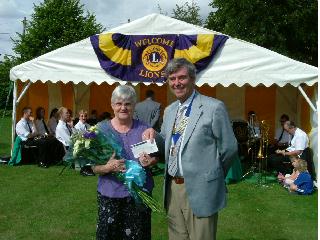 Lion President John presenting Sheila Jones with the cheque