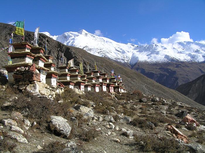 Row of chortens with Kang Guru as backdrop